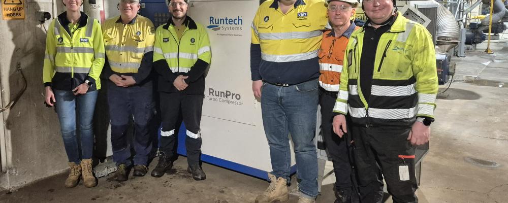 Visy and Runtech teams photographed next to a RunPro Turbo Compressor. From the left: Alessandra Bandeira, Michael Coleman, Leonardo Bau, Cameron Heins, Bruce MacGregor and Mika Tähtinen. Photo: Runtech