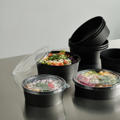 The collection consists of black paper-based trays and bowls with a functional barrier, combined with transparent lids for clear on-shelf and take-away visibility. Photo: Duni Group